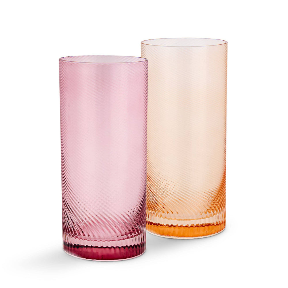 Two textured glass tumblers, one pink and one peach, on a white background