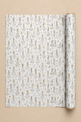 A roll of wrapping paper unrolled to show a repeating pattern of small illustrated girls in white dresses with floral details, set against a solid beige background.