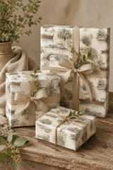 Vintage riverbank wrapping paper with countryside scene and subtle colour accents.