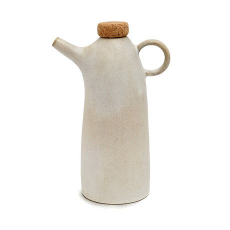 White ceramic oil dispenser with cork lid on a white background