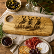 Wooden charcuterie board with rabbit design on a table with food items
