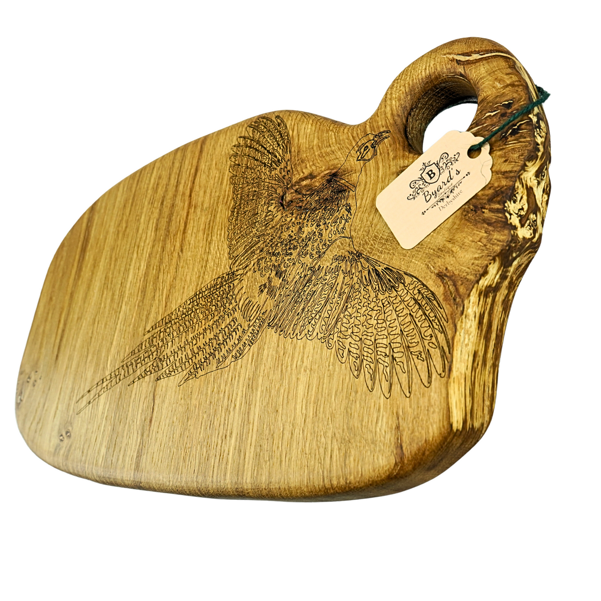 Wooden cutting board with engraved pheasant design and a tag on a white background