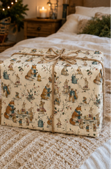 Illustrated woodland animal Christmas wrapping paper featuring scarf-wearing foxes, rabbits and mice sharing hot drinks and mince pies at a winter garden party. The pencil-sketch design includes lanterns, wrought-iron tables, watering cans, holly and snowy branches in teal, russet, pink, mustard, red and green on warm ivory.