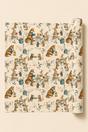 Illustrated woodland animal Christmas wrapping paper featuring scarf-wearing foxes, rabbits and mice sharing hot drinks and mince pies at a winter garden party. The pencil-sketch design includes lanterns, wrought-iron tables, watering cans, holly and snowy branches in teal, russet, pink, mustard, red and green on warm ivory.