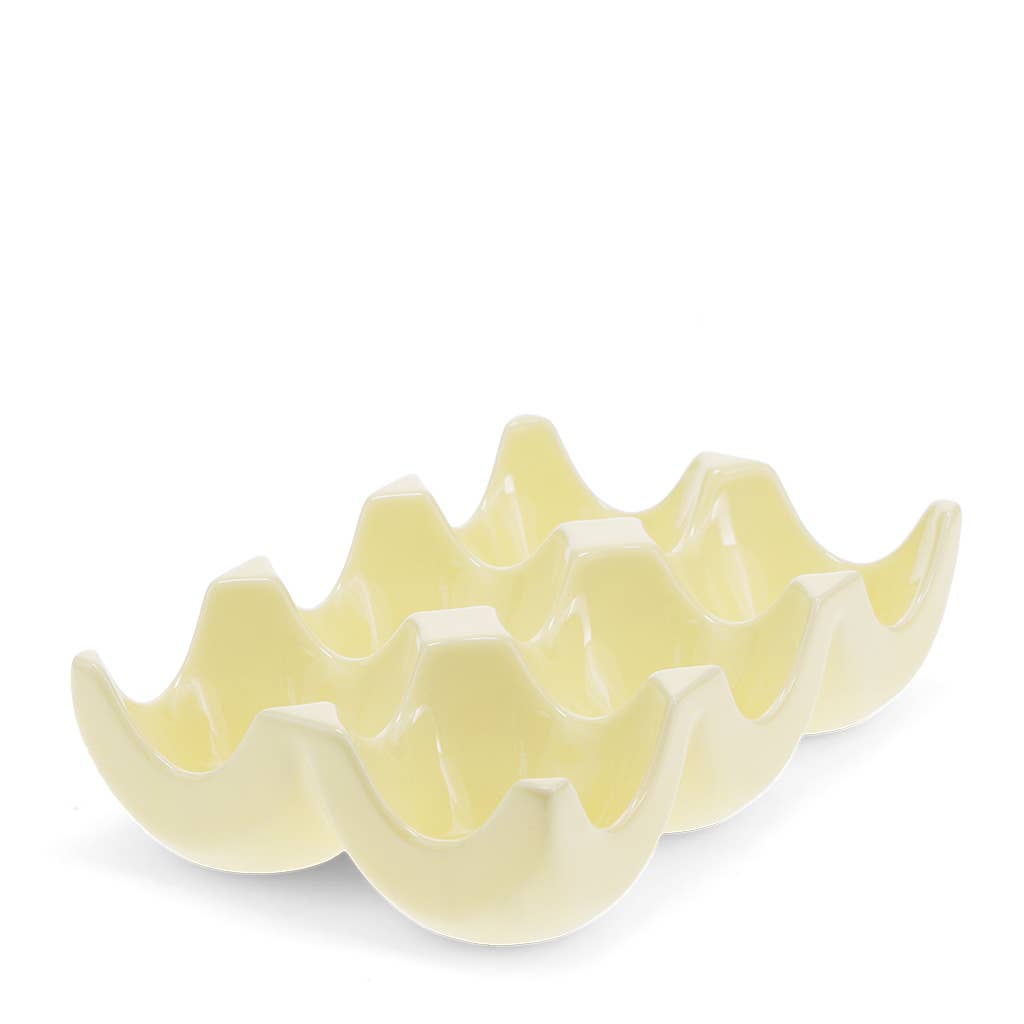 Yellow ceramic egg holder on a white background