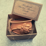 Handmade beeswax candle in a cardboard box with 'Handmade Blended Beeswax Candle' text.