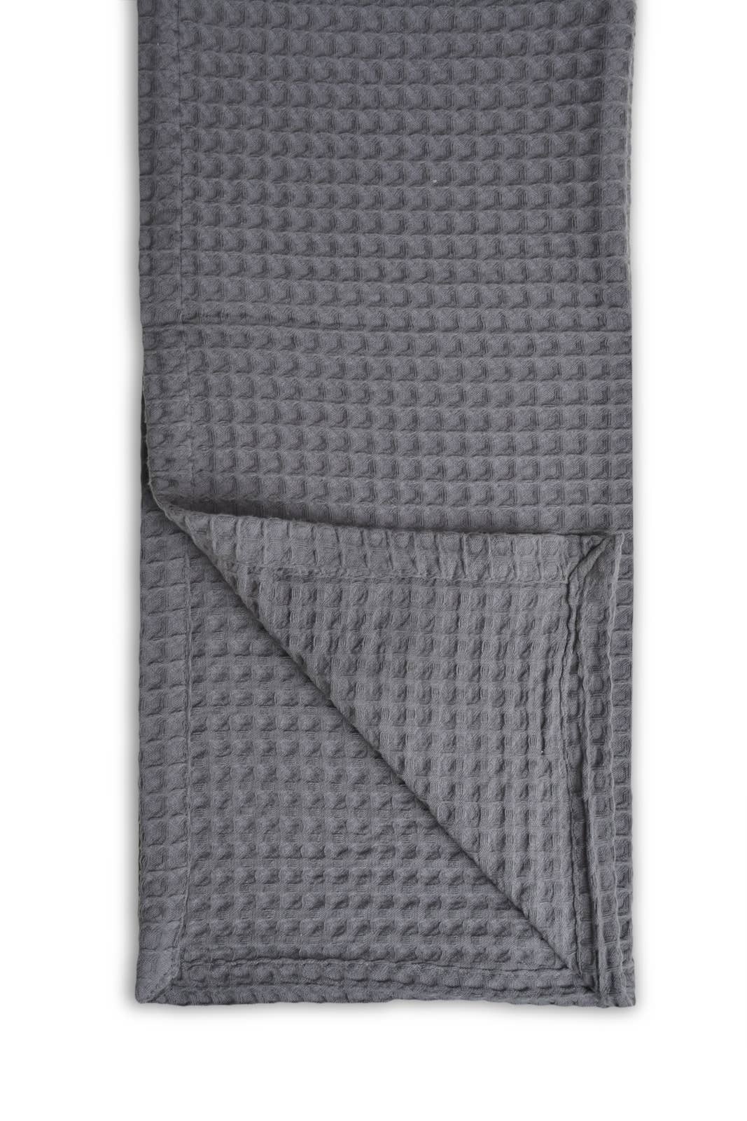Grey textured blanket folded on a white background