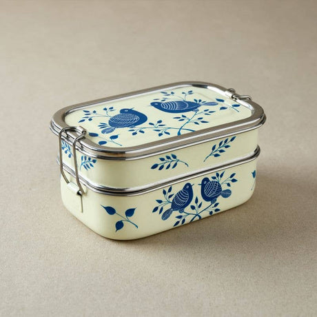 Rectangular tiffin tin food container with blue bird design on a beige background