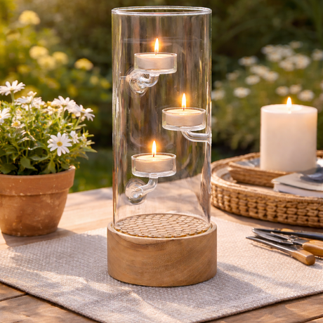 Decorative candle holder with candles on a wooden table outdoors