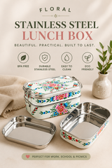 Stainless steel lunch box with floral design on a neutral background