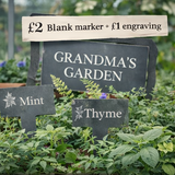 Advertisement for custom engraved slate plant markers with various promotional offers.