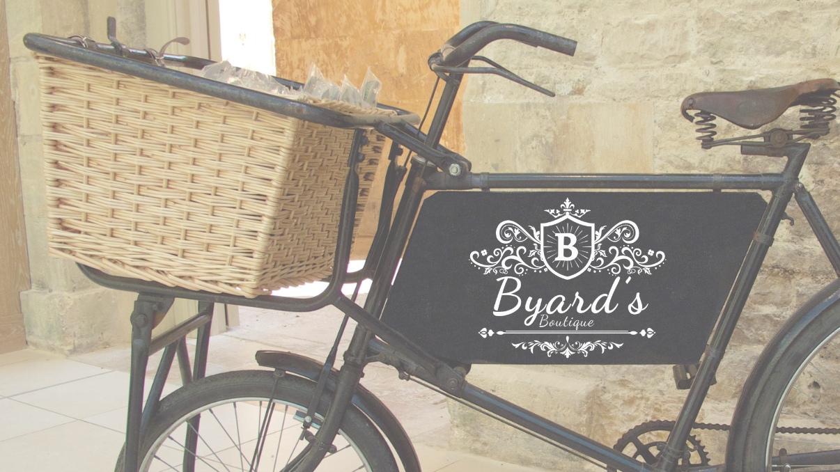 Vintage bicycle with a basket against a stone wall.