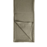 Waffle-textured throw 100% cotton folded neatly on a white background