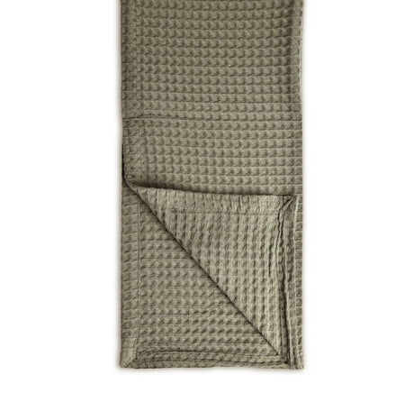 Waffle-textured throw 100% cotton folded neatly on a white background