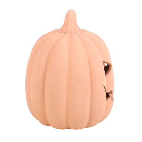 Pumpkin-shaped container with a face cutout on a white background