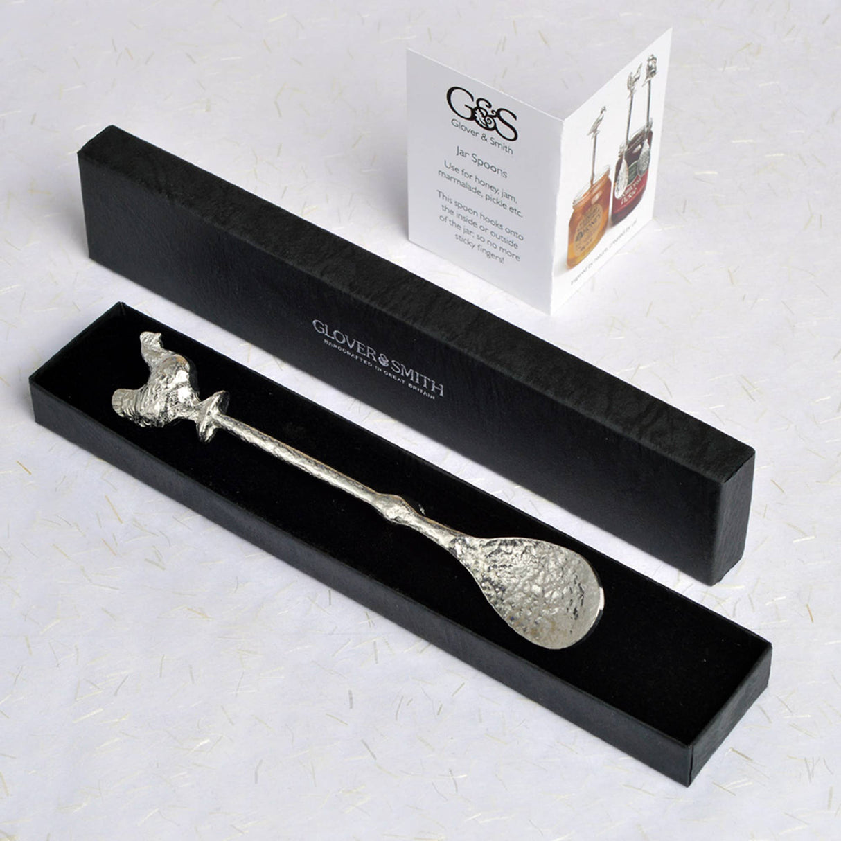 Decorative jam spoon with a chicken on top in a black box 