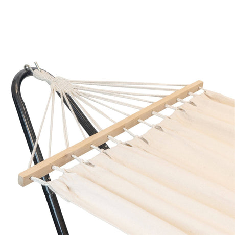 White hammock with wooden beams and black metal stand on a white background