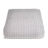 Grey textured ottoman on a white background