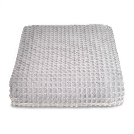 Grey textured ottoman on a white background