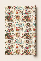Festive sheep Christmas wrapping paper roll with sheep, fairy lights, gifts and sleighs on a cream background.