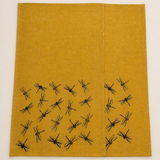 Two Mustard yellow linen tea towels with black hand printed dragonfly patterns on a white background