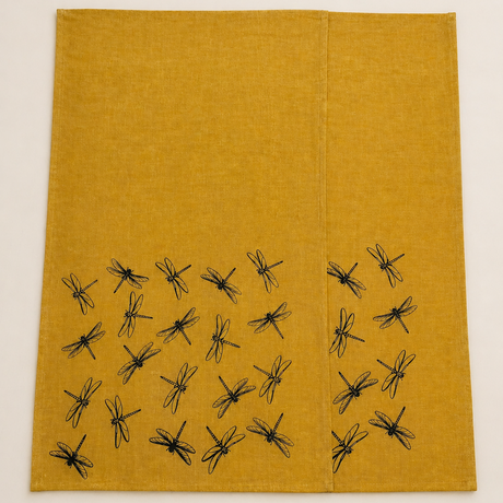 Two Mustard yellow linen tea towels with black hand printed dragonfly patterns on a white background