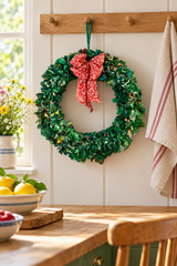 Green 45cm sari fabric wreath on a kitchen peg rail