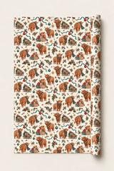 Small-pattern Highland cow Christmas wrapping paper roll with a closely repeated festive design on a cream background