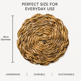 Woven placemat with dimensions and sustainability text on a white background