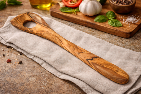 Wooden spoon on a towel with ingredients in the background