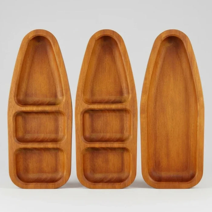 Three wooden boat-shaped trays on a white background
