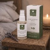 Pure Lakes Sleep & Room Spray bottle and packaging on a wooden surface with lavender and a candle in the background.