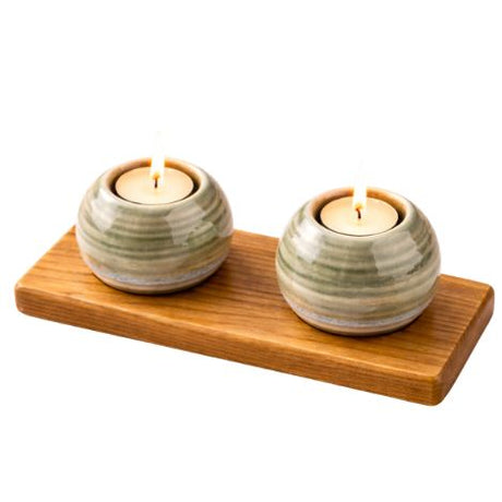Two ceramic candle holders with wooden tray on a white background