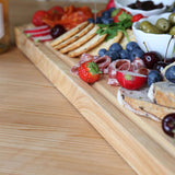 Close-up of the 60 × 40cm rubberwood butcher’s block serving bread, salami, strawberries, blueberries and olives.
