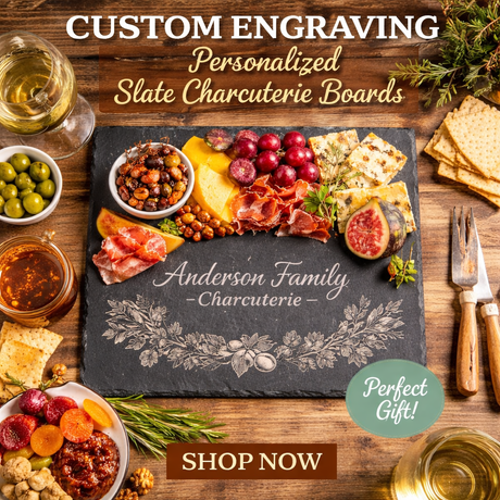 Personalized slate charcuterie board with food items and 'Anderson Family Charcuterie' engraving on a wooden surface.