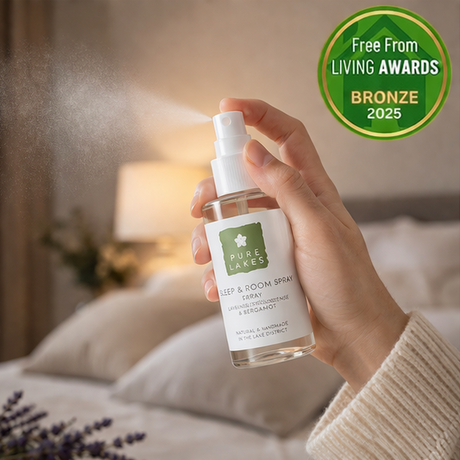 pure lakes Room Spray with a hand holding the product.