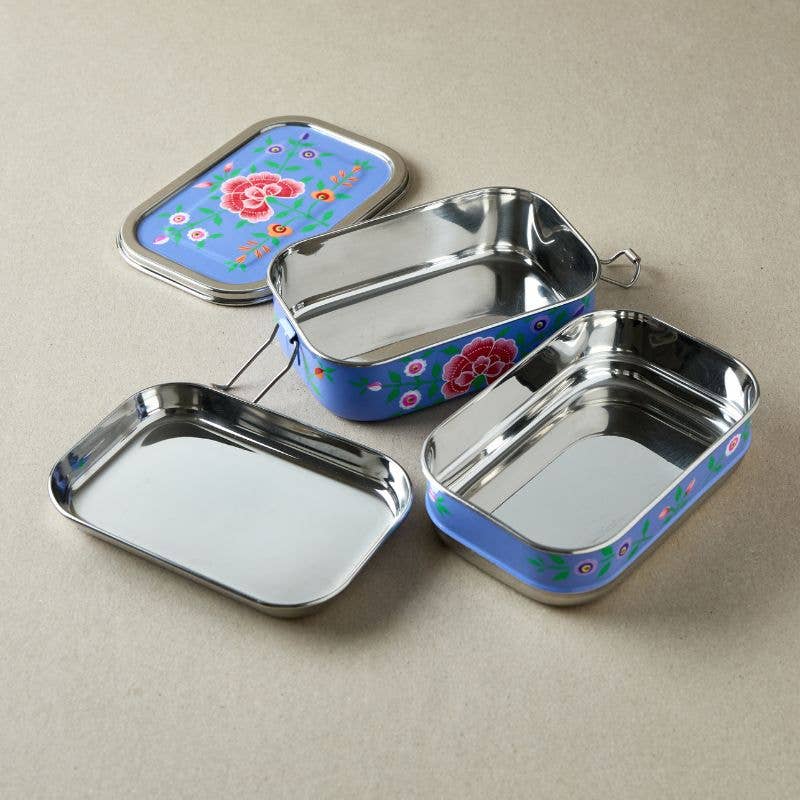 Violet tiffin tin with floral design metal lunch boxes with floral designs on a beige background