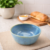 blue stoneware bowls in various settings including a kitchen.