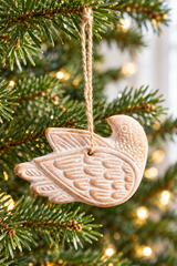 Close-up of feather relief on a whitewashed terracotta bird ornament