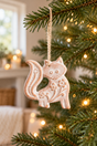 Whitewashed terracotta fox Christmas decoration hanging on a fir branch