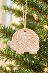 Close-up of raised hedgehog detail on a terracotta Christmas ornament