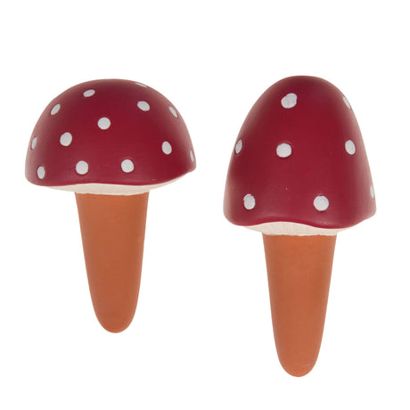 Set of two terracotta plant watering spikes with red mushroom caps, white spots and white detailing. 