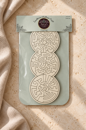 Three Rings easier wooden puzzle in its packaging on pale limestone and linen, showing white pieces and intricate laser-cut shapes.