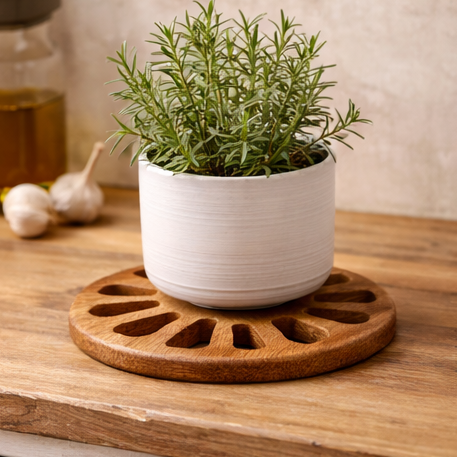 Wooden trivets being used with various items including a plant, teacup, pot of food, and candle.