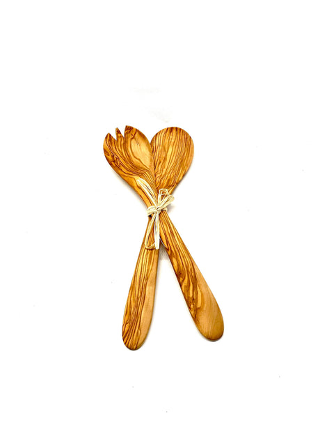 Wooden salad servers tied with a ribbon on a white background