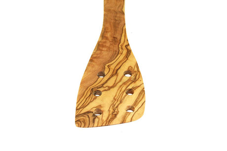 Wooden spatula with a wavy pattern on a white background