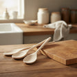 Set of four wooden spoons on a white background