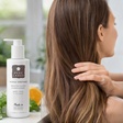 a woman using Pure Lakes hair care products with the product displayed in frame.