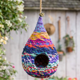 Collage of colorful woven birdhouses in a garden setting
