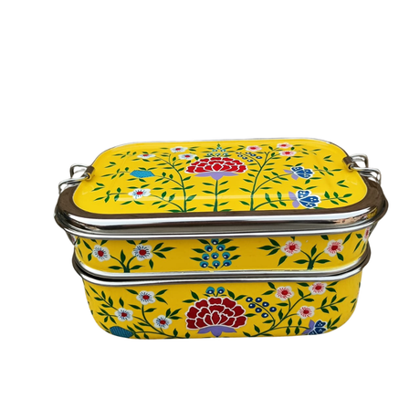 tiffin tin Stackable metal containers with floral design on a yellow background